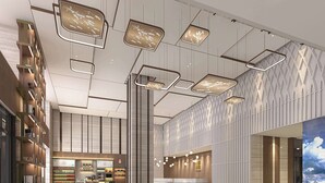 A spacious lobby with a checkered floor, a reception desk, and a large digital display. - Hilton Garden Inn Ili Yining (Yining)