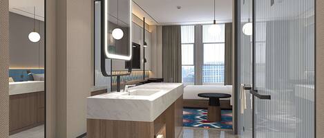 A modern bathroom with a marble vanity, a large mirror, and a glass shower enclosure.