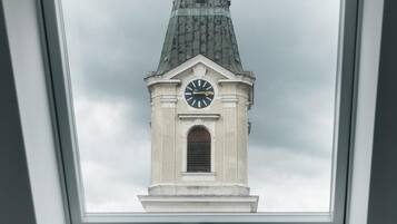 A skylight with a view of a clock tower.