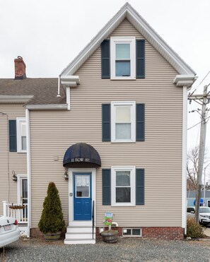 Welcome to 11 Bow Street, a charming two-story residence with a cozy front entrance.