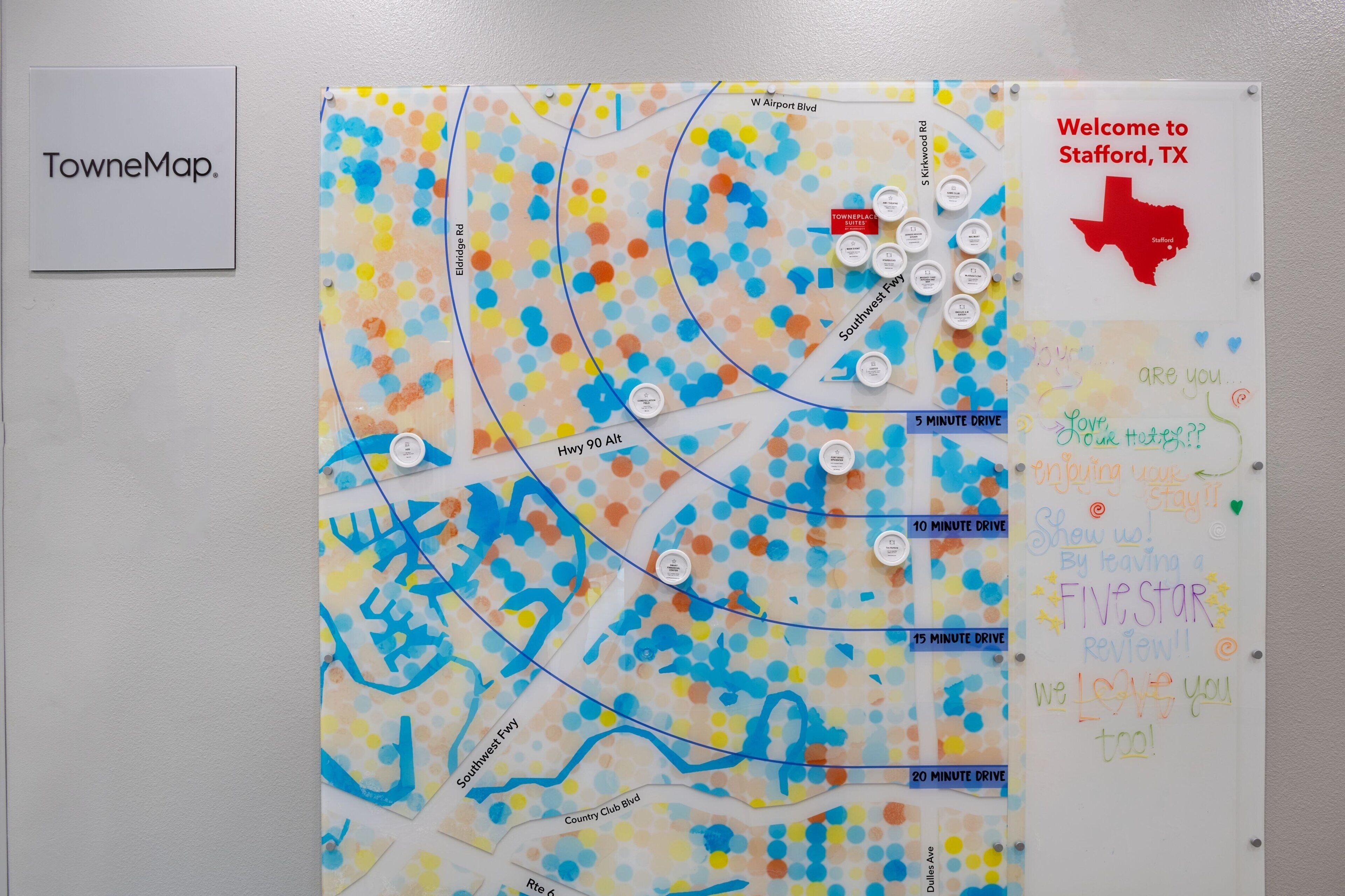 A colorful map with location markers and a welcome sign for Stafford, TX.