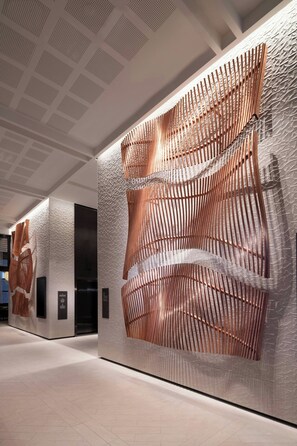 A modern interior with textured walls and a patterned ceiling.