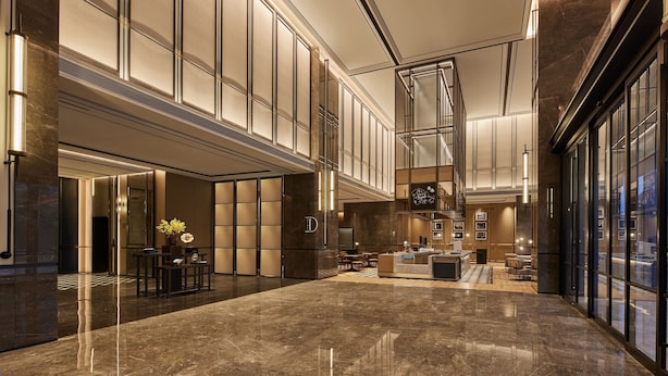 A spacious lobby with a reception desk, seating area, and a large window offering a view. - Four Points By Sheraton Linhai (Taizhou)
