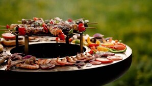 A grill with various meats and vegetables.