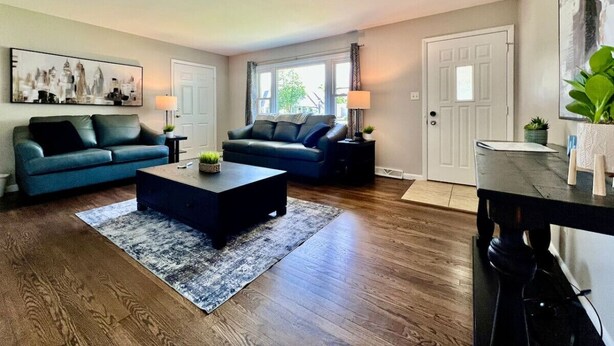 A living room with two sofas, a coffee table, and a TV stand. - Cute Ranch home Middletown, OH (Middletown)