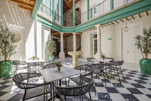 Enjoy dining or socializing in this airy space with high ceilings and a balcony overlooking the surroundings.