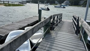 A wooden pier with boats docked at the end. - Cute, cozy and newly built bungalow on private street awaits your Capecod visit. (Mashpee)