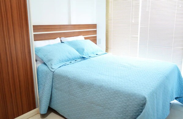 Restful retreat with a comfortable bed and wooden headboard.