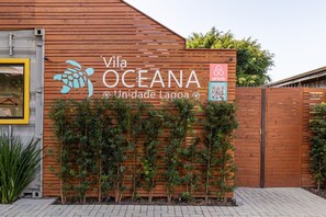 Vila Oceana's exterior features a distinctive wooden panel design and a welcoming entrance.