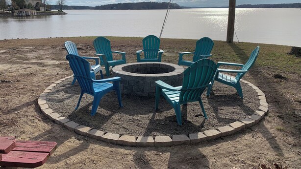 A circular seating area with six Adirondack chairs around a fire pit, overlooking a lake. - Lakefront spectacular view 

























 (Henrico)