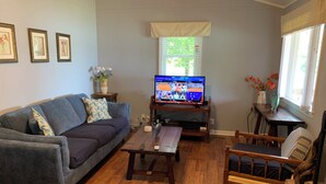 A living room with a sofa, armchairs, a coffee table, and a television displaying a sports event. - Lakefront spectacular view 

























 (Henrico)