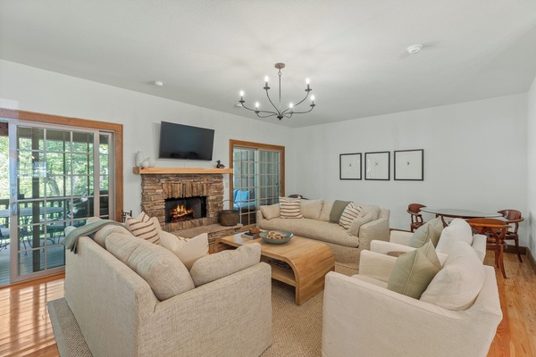 Living room with plenty of seating, fireplace and sliding doors to the back deck