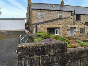 A stone house with a white garage, a garden with flowers, and a sign reading 'New House Farm'. - New House Farm - UKC6912 (Cowan Bridge, near Kirkby Lonsdale)