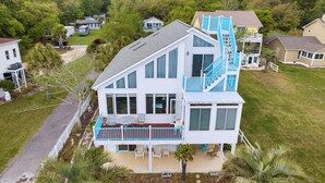 A two-story house with a balcony, a staircase, and a front porch.