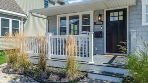 A house with a front porch, a dark front door, and a mailbox. - 3BR Wildwood Crest Family Home - Easy walk 2 beach (Wildwood Crest)