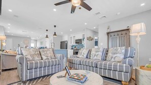 A spacious living room with striped sofas, a marble coffee table, and a ceiling fan. - 3BR Wildwood Crest Family Home - Easy walk 2 beach (Wildwood Crest)