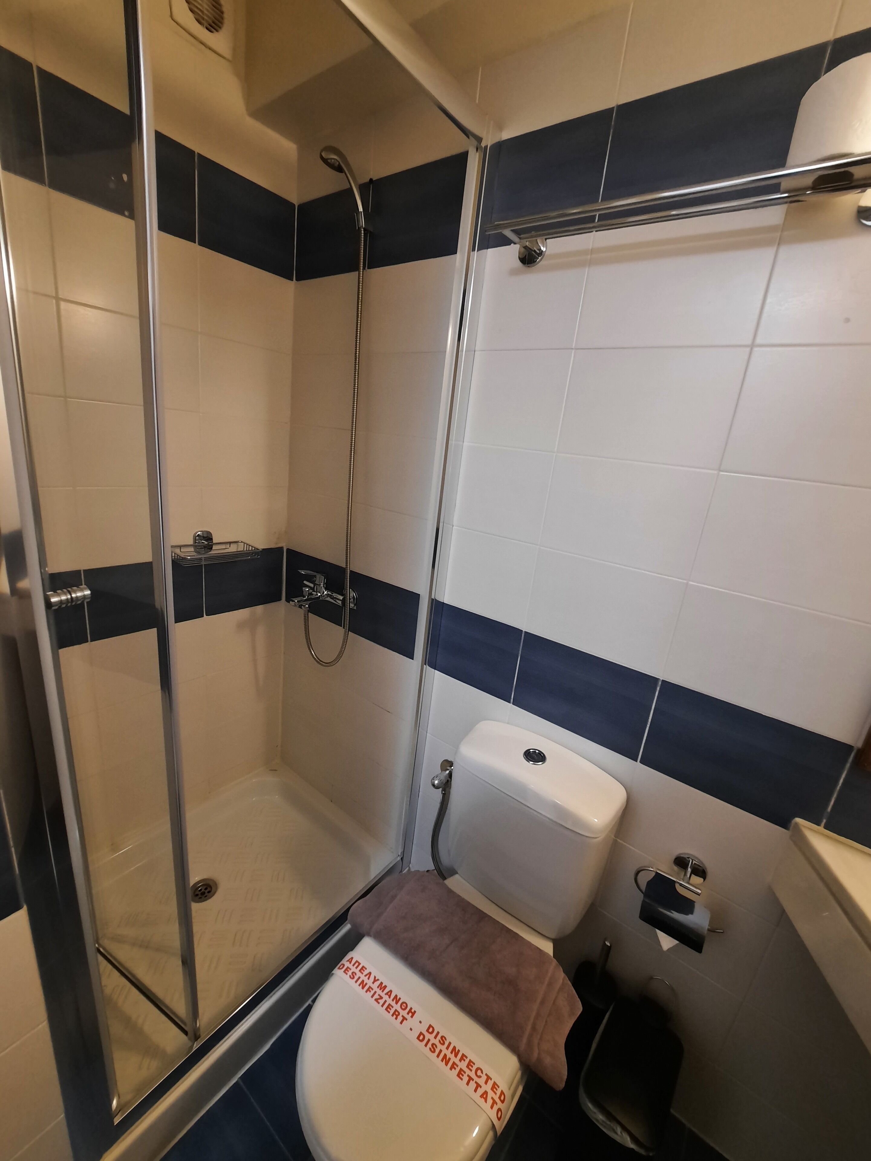 A bathroom with a glass-enclosed shower, a toilet, and a bidet.