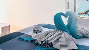 A hotel room with a bed, a view of the sky, and a door leading outside. - Villa Janubio With 3 Bedrooms and 2 Bathrooms (Yaiza)