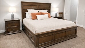 A bedroom with a large bed, two bedside tables, and a door. - Two Heated Pools/Spas, BBQ, Golf Course (Washington)