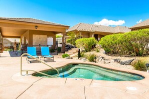 A swimming pool with lounge chairs and a covered patio area. - Two Heated Pools/Spas, BBQ, Golf Course (Washington)