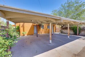 A covered outdoor area with a concrete floor, a wooden door, and a brick wall. - Central & Quaint Phoenix Condo - Pets Welcome! (Phoenix)