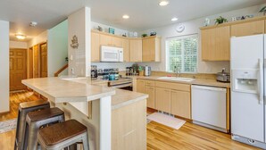 Una cocina moderna con armarios de madera, una isla central y electrodomésticos integrados.