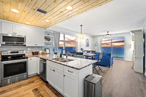 Spacious luxury awaits in this corner unit with wide beach and ocean views