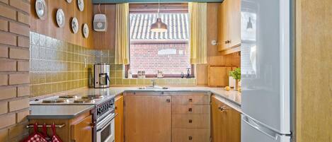 Fridge, stovetop, dishwasher, coffee/tea maker