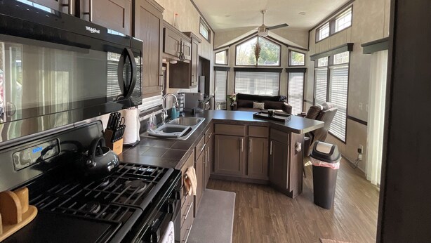A modern kitchen with a built-in stove, microwave, and sink. - WALK TO INDIAN RIVER MARINA AT NORRIS LAKE
Book now! Memorial Weekend available (Jacksboro)