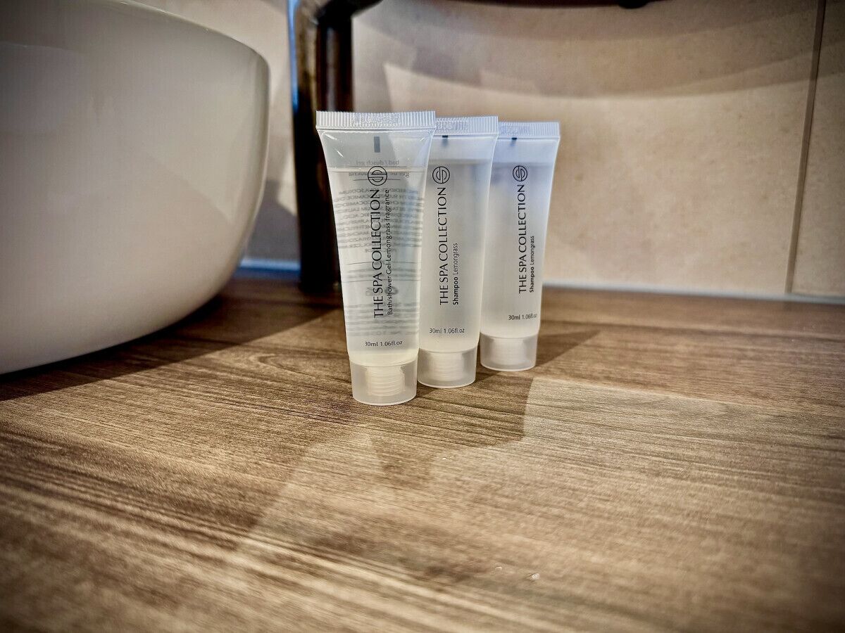 Three tubes of shampoo collection on a wooden surface.
