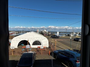 A parking lot with a tent and a fenced area marked for employee use. - Dock Street Inn (Westport)