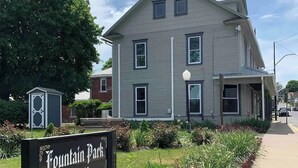 A two-story building with a sign reading "Fountain Park Est. 2000" in front. - Millheim Mallard Place (Millheim)