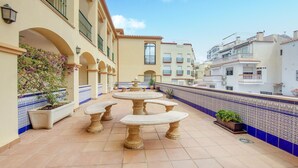 A rooftop terrace with outdoor seating and potted plants. - 2 bedroom stunning apartment in Nerja (Nerja)