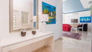 A modern bathroom with a large mirror, a white vanity, and decorative vases. - Stunning home in Poljane (Poljane)