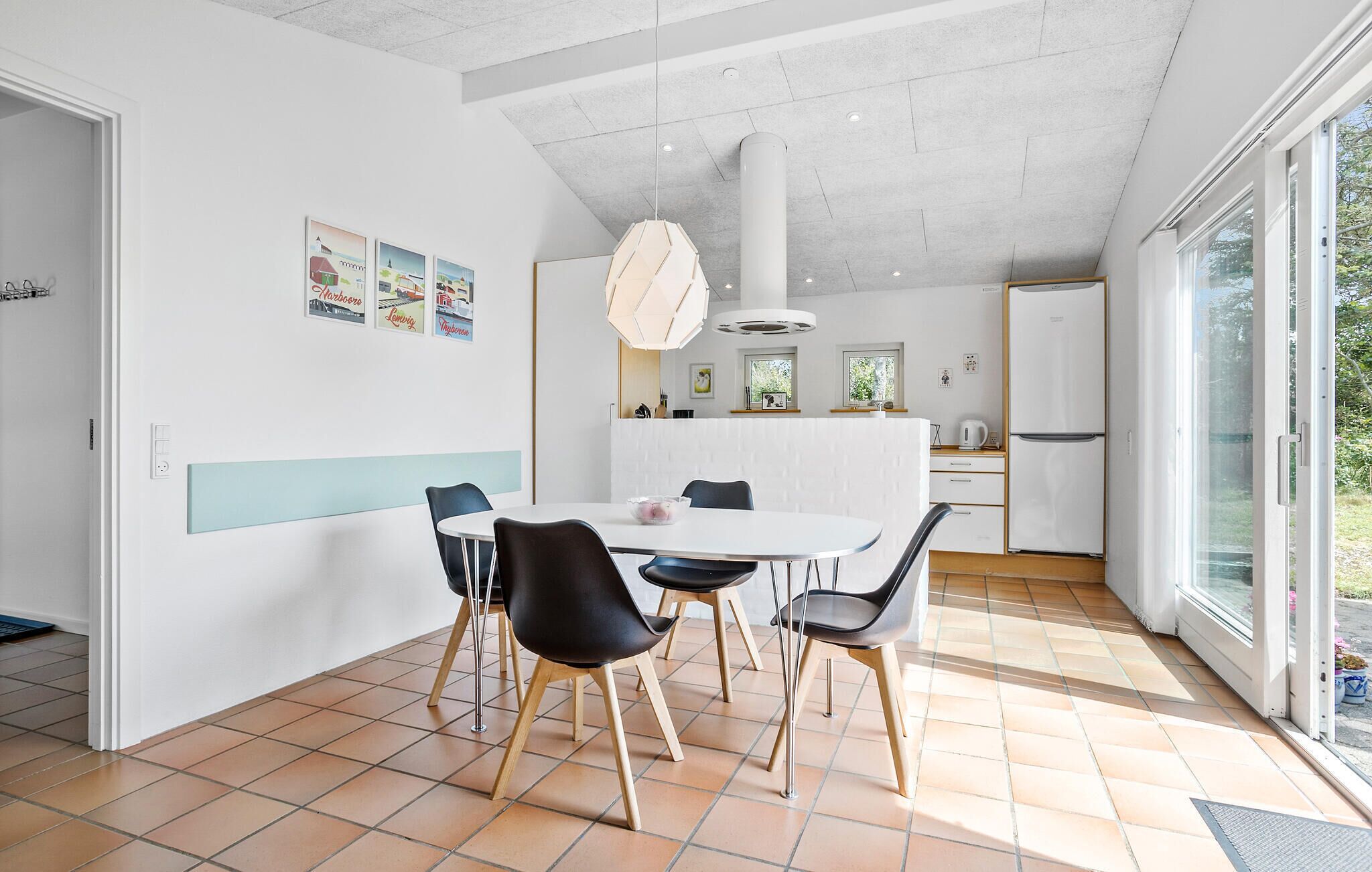 A modern kitchen with a white countertop, a built-in oven, and a refrigerator.