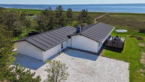 A modern two-story house with a gravel driveway and a patio area. - Lovely home in Hurup Thy with WiFi (Hurup Thy)