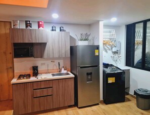 Fridge, microwave, coffee/tea maker, cookware/dishes/utensils