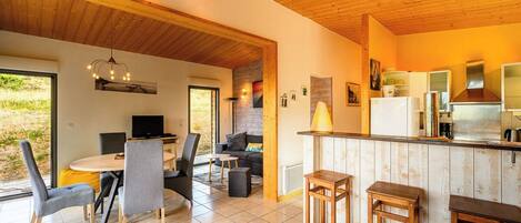 A modern interior with a dining area, kitchen, and seating space.