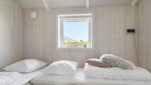 A room with two beds, a window with a view of greenery, and a small wall-mounted device. - Stunning home in Haderslev with WiFi (Haderslev)