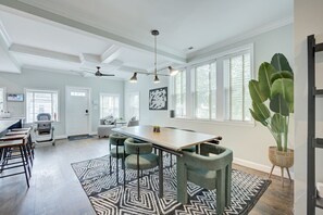 A spacious kitchen with a large island, bar stools, and a ceiling fan. - DC`s premier group home 5 bedrooms, 11 guests, EV charging, free parking (Washington)