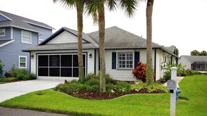 A single-story house with a garage, surrounded by a well-maintained lawn and palm trees. - Palm Coast, FL/Sea Colony house

 (Palm Coast)