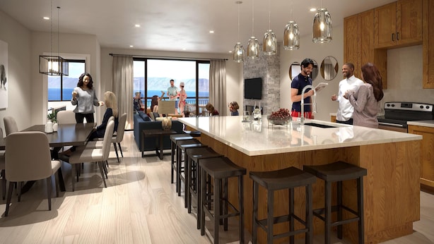 A modern kitchen with a large island, bar stools, and wooden cabinetry. - Water's Edge Suite 201 - Beautiful, Spacious & Luxurious (Garden City)