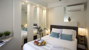 A hotel room with a bed, bedside table, and a ceiling fan.