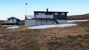 A two-story house with a balcony and a flagpole. - 3 bedroom cozy home in Snefjord (Snefjord)