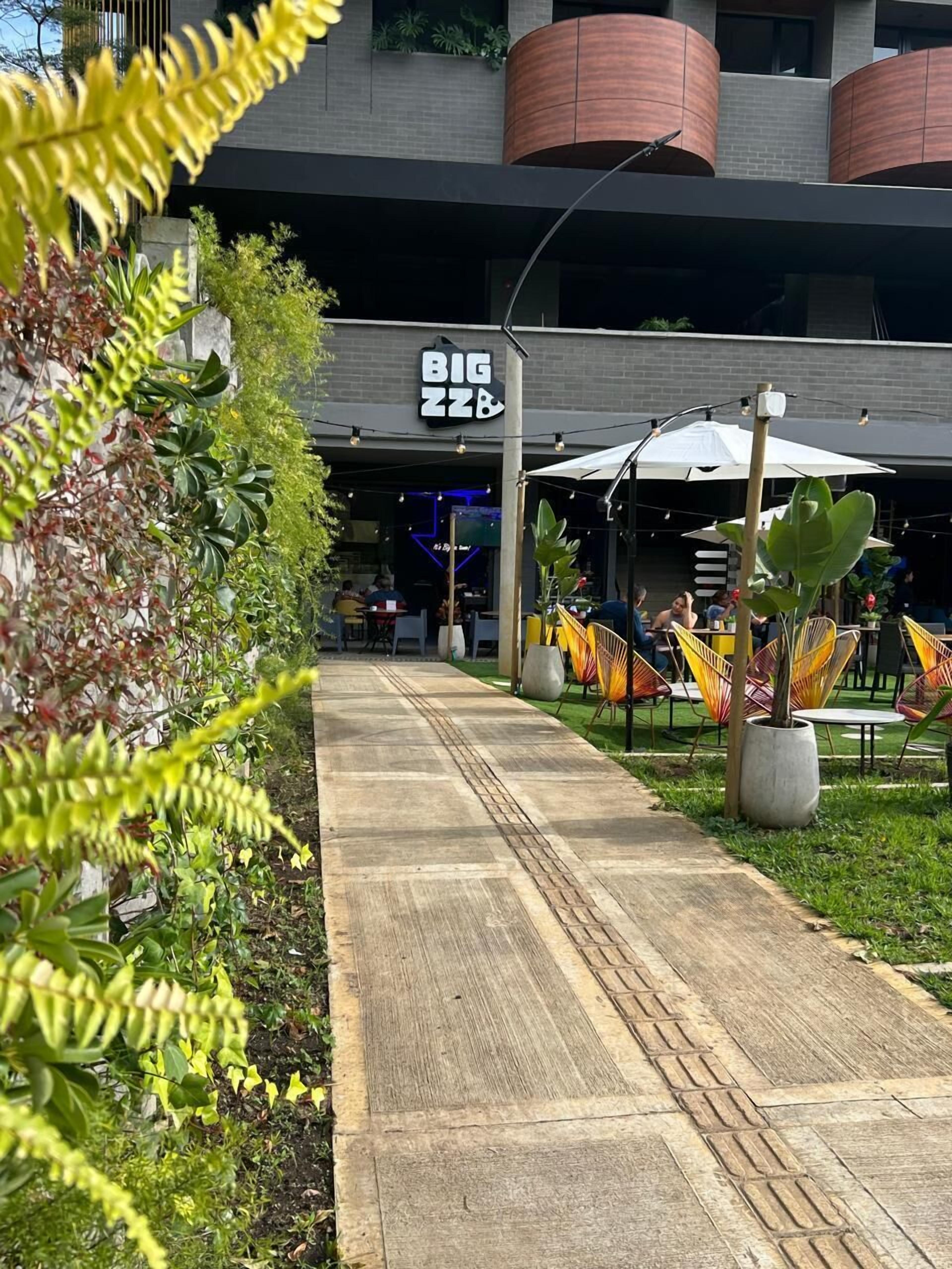 A pathway leading to a building with a sign reading "BIG ZZZ".