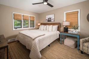 A bedroom with a bed, a desk, a chair, a ceiling fan, and a window with blinds. - Peaceful Mtn Cabin - Hot Tub- Downtown Boone (Boone)