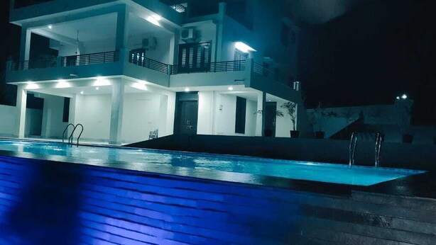 A modern two-story building with a swimming pool in front. - The Udaisagar Retreat - Udaipur (Udaipur)