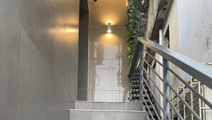 A staircase with a metal railing, leading to an upper floor.