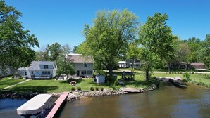 A residential area with a pond, houses, and a dock. - Lake Winnebago Water Front! Fishing! Boating! Quiet Bay! EAA! (Oshkosh)
