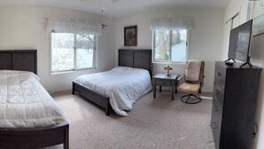 A bedroom with two beds, a desk, a chair, and a dresser. - Lake Winnebago Water Front! Fishing! Boating! Quiet Bay! EAA! (Oshkosh)